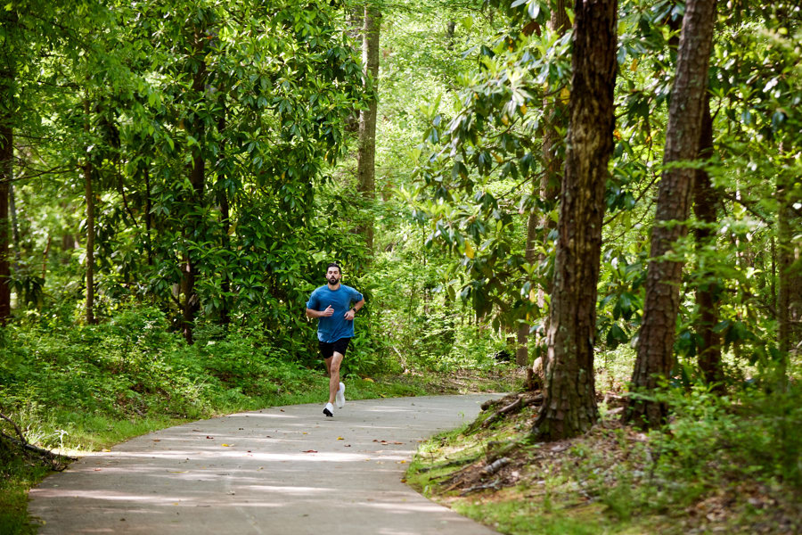 jogger in the woods on a trail